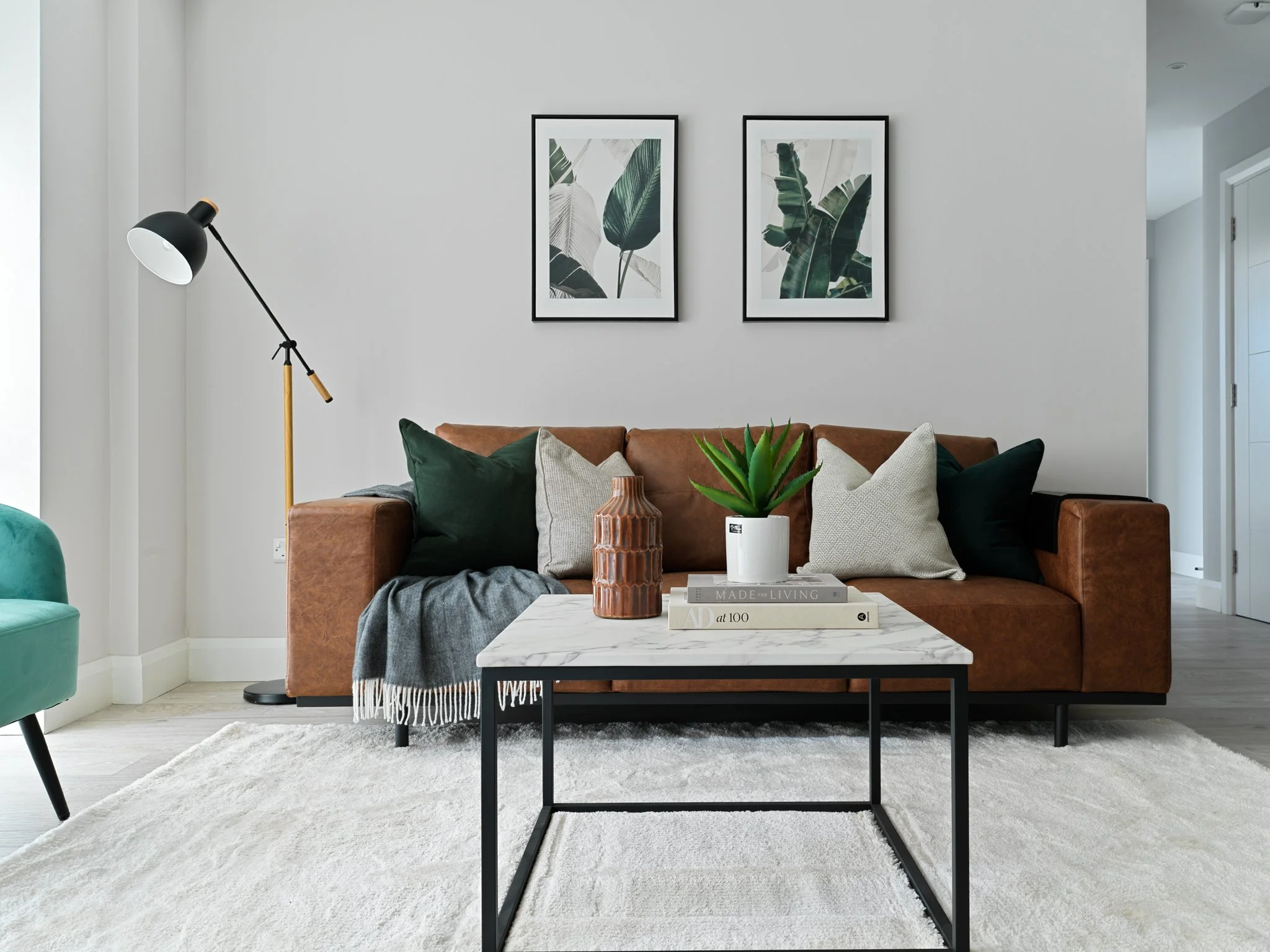 brown leather couch in bright contemporary apartment