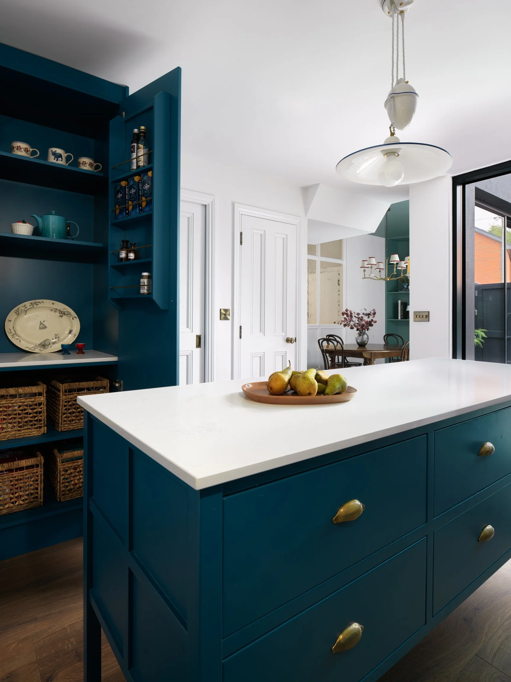 Teal kitchen island with teal cupboards