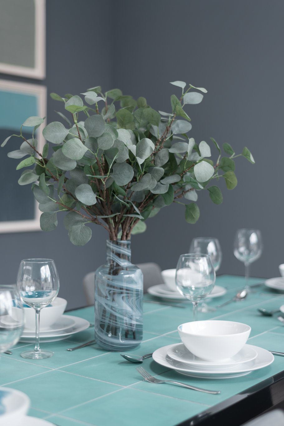 teal dining table detail with greenery