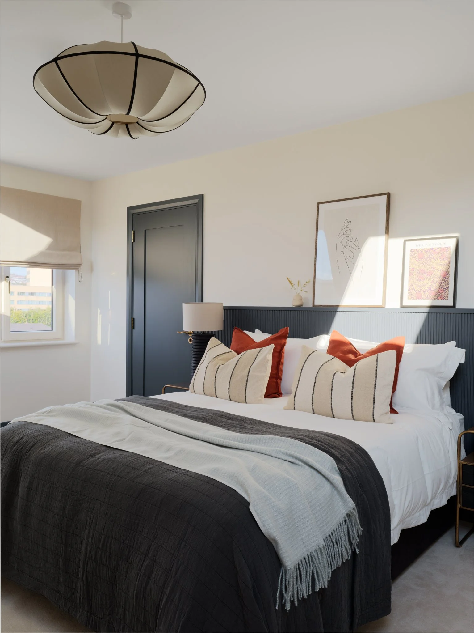 sunlight on double bed with navy & cream interior design