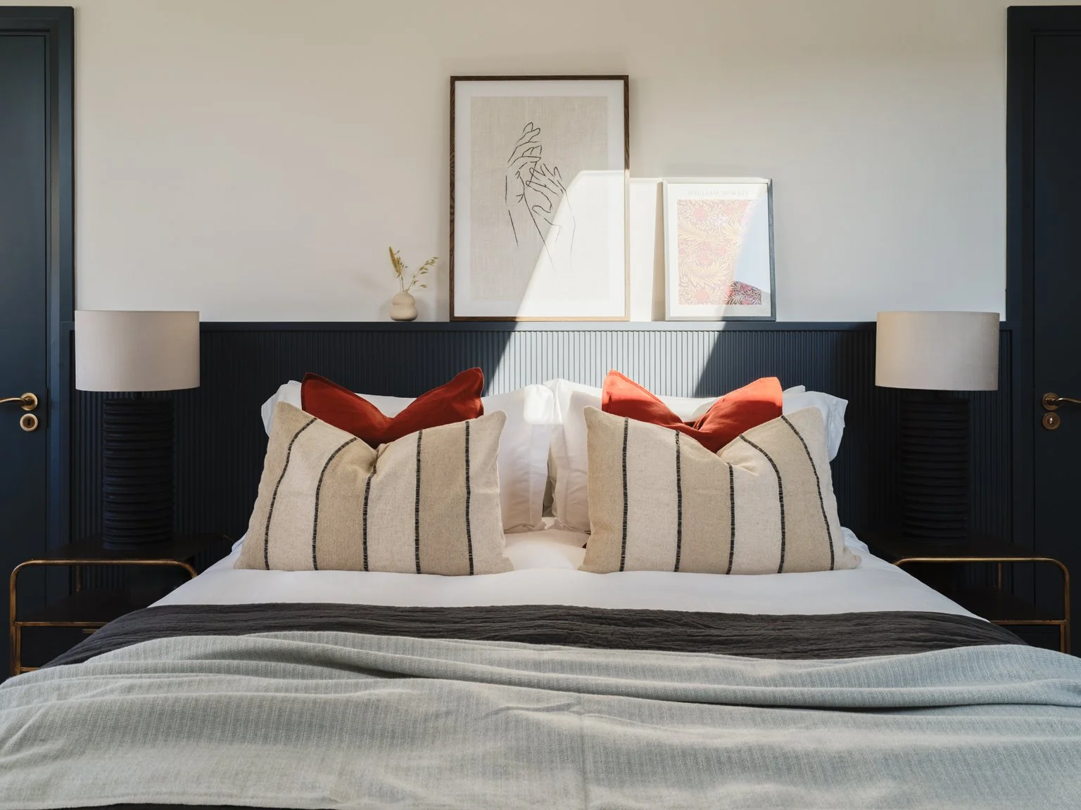 navy double bed headboard with artwork