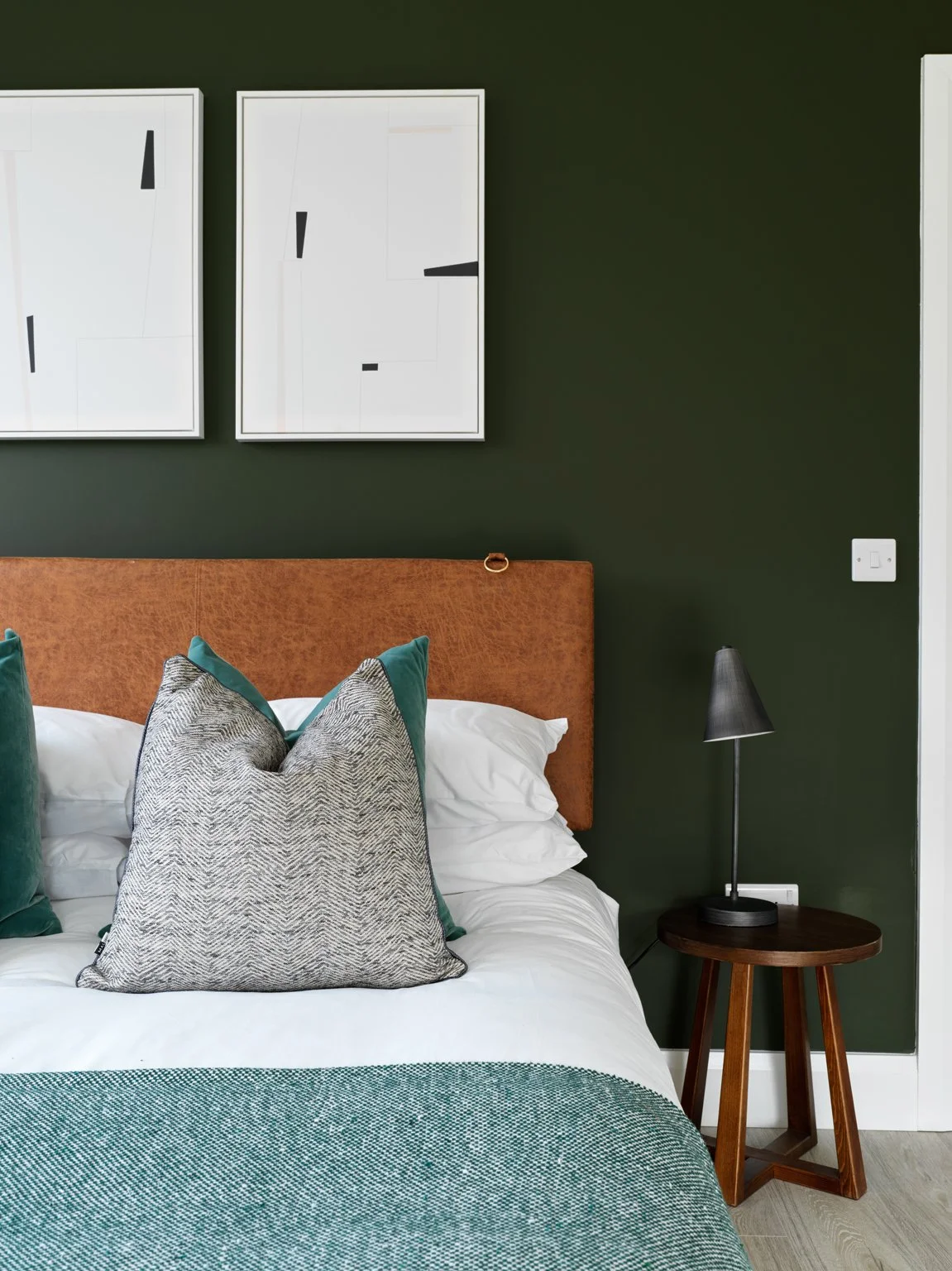 brown divan bed with moss green walls
