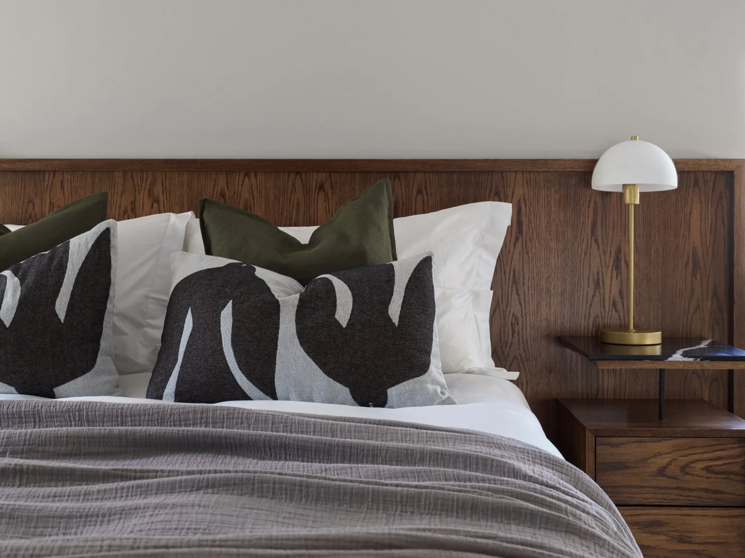 mahogany headboard made by custom joinery and gold bedside lamp