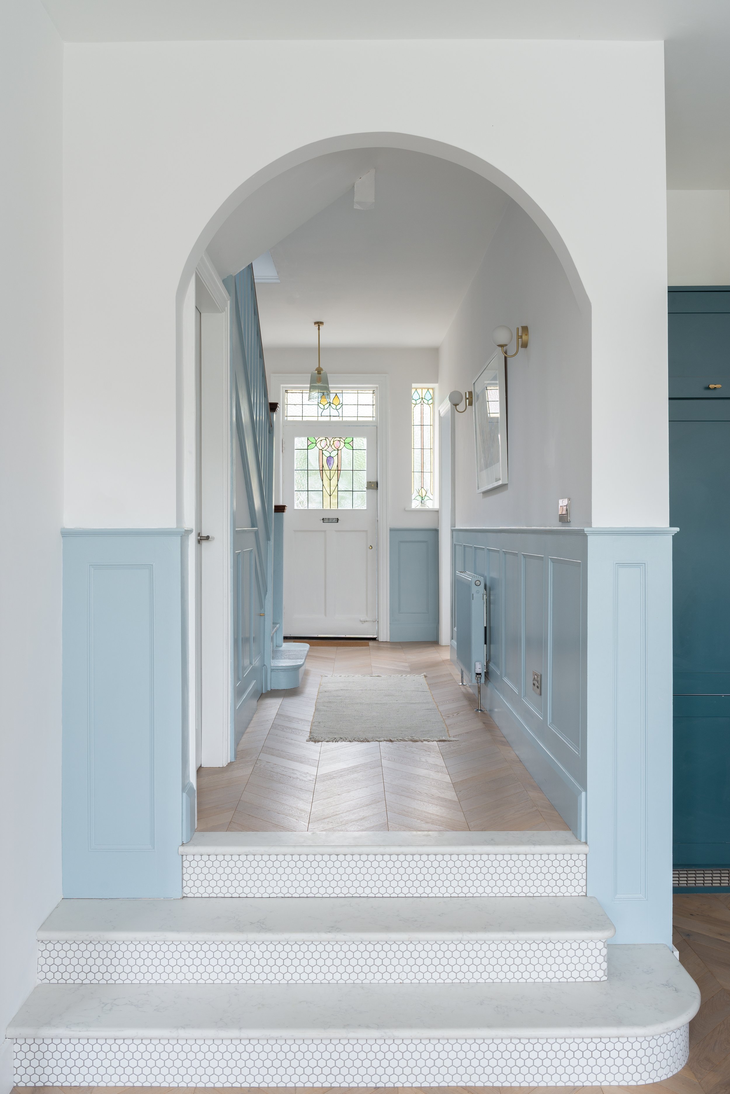 pale blue and white steps into hallway space