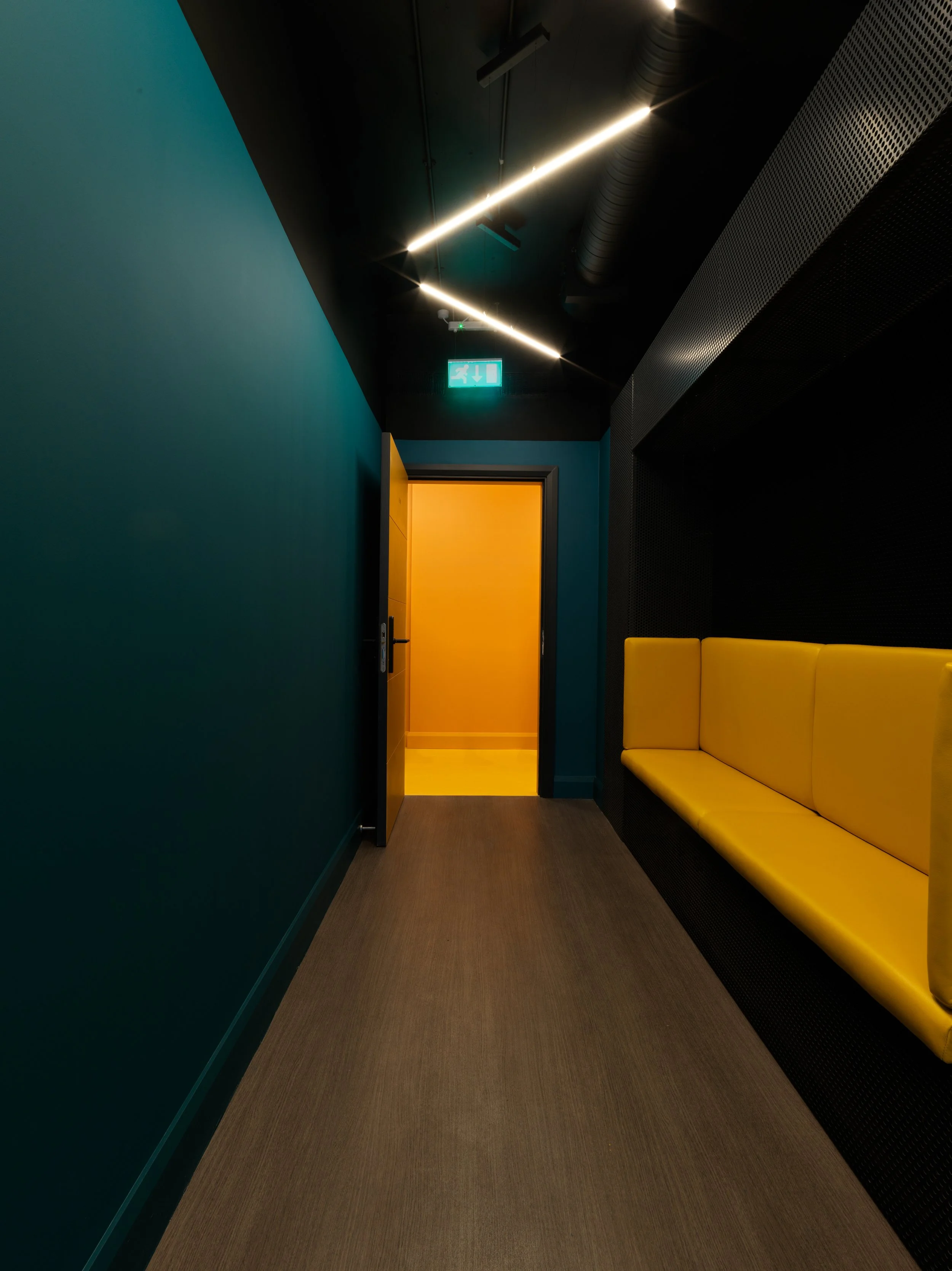 yellow bench with teal wall