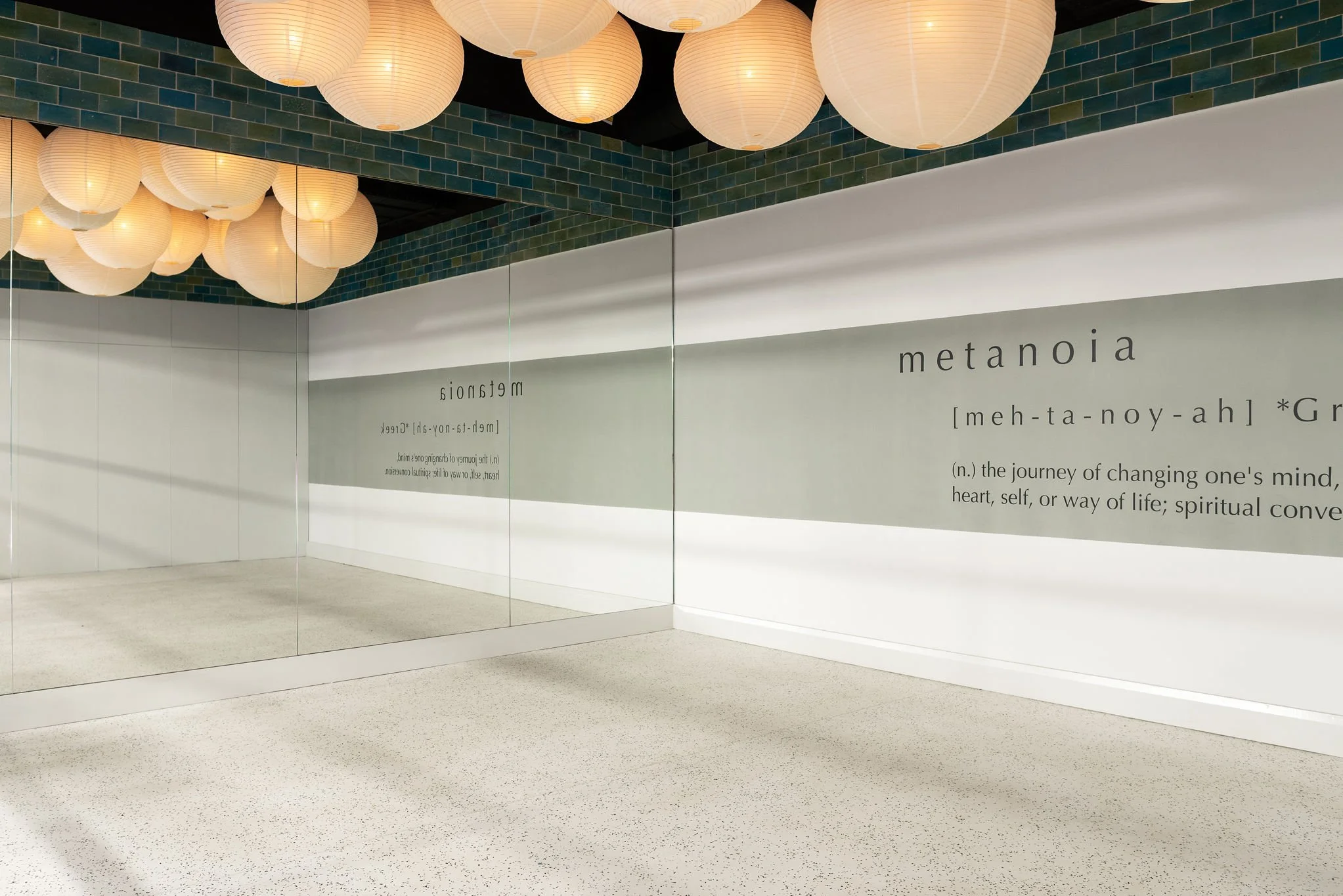 yoga studio with large mirror and cloud like lamps