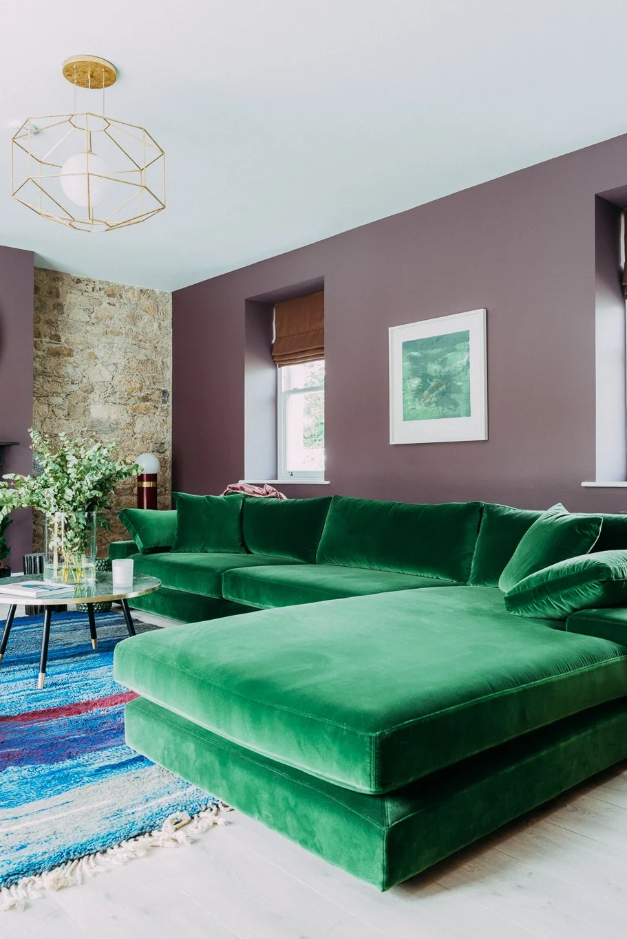 plum living room with large green L sofa