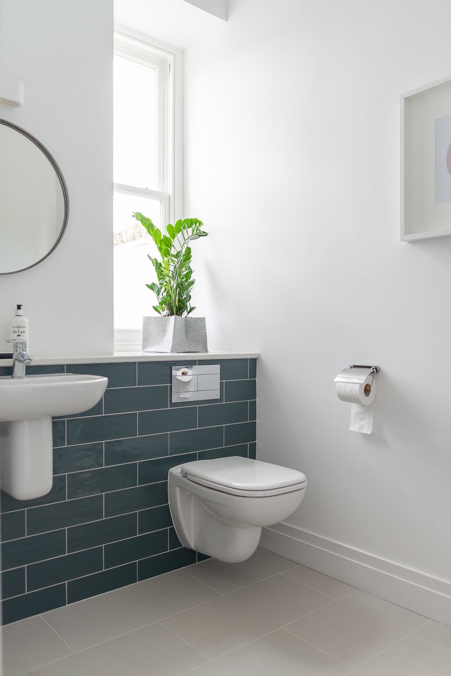 white bathroom with teal subway tiles