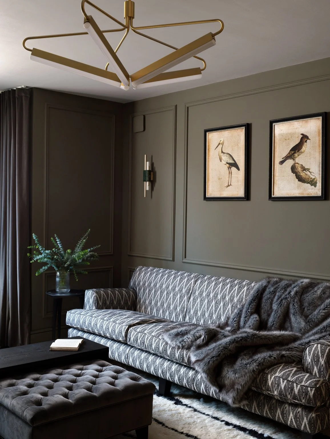 sage green interior design living room with blue patterned couch