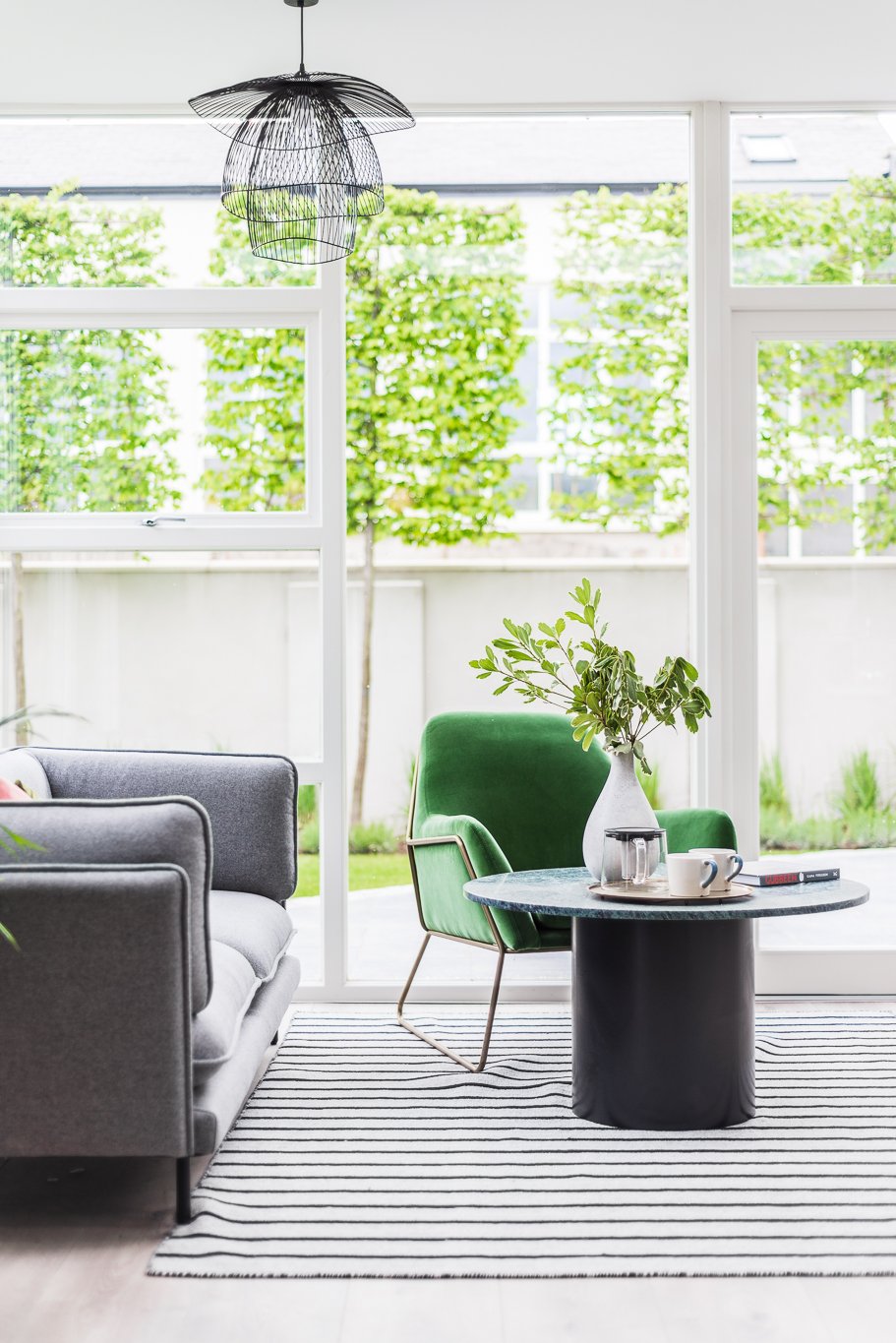 glazed living area with green armchair 