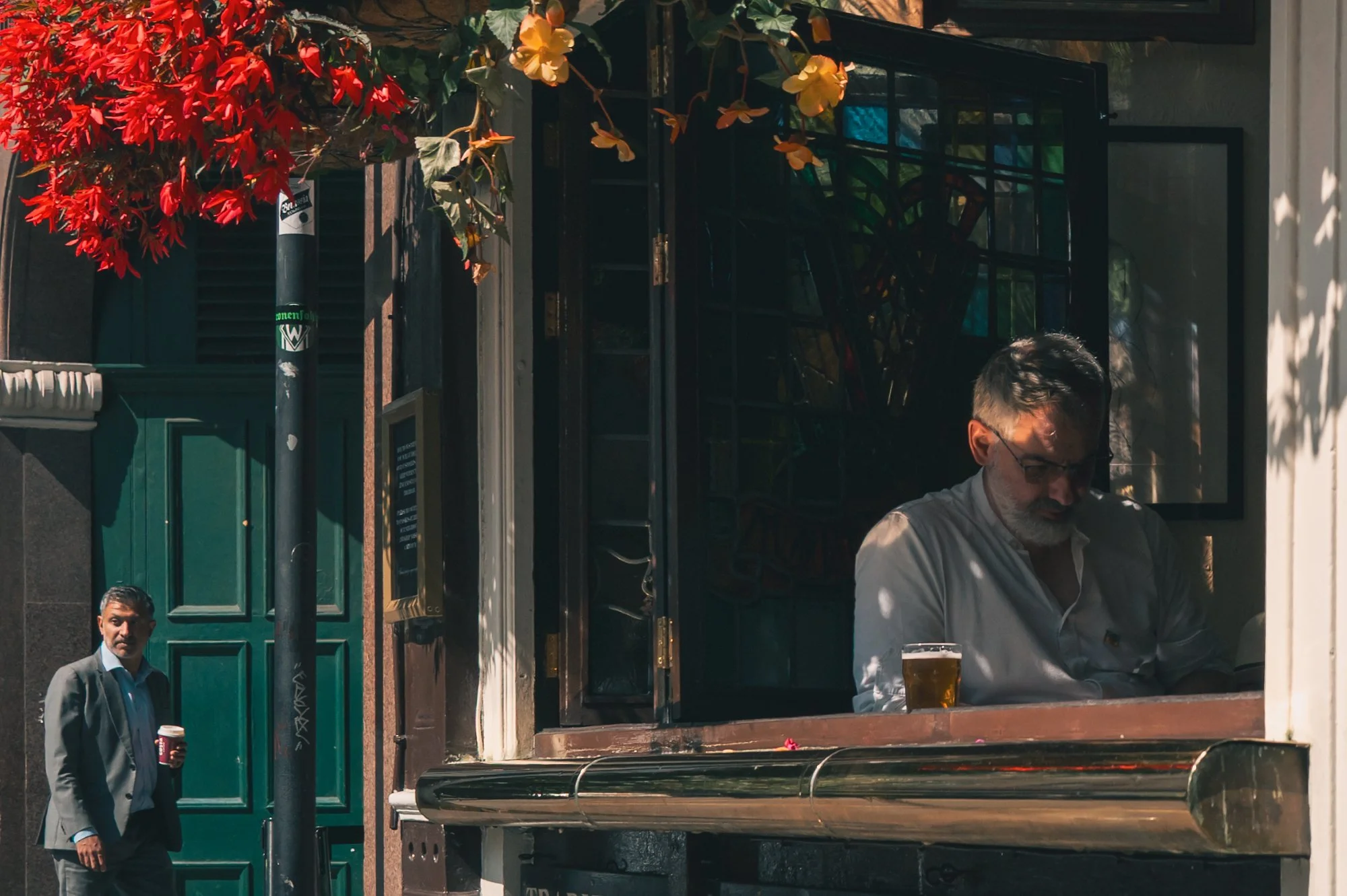 Print AD-0008. A pub interior and the street held together through a window.