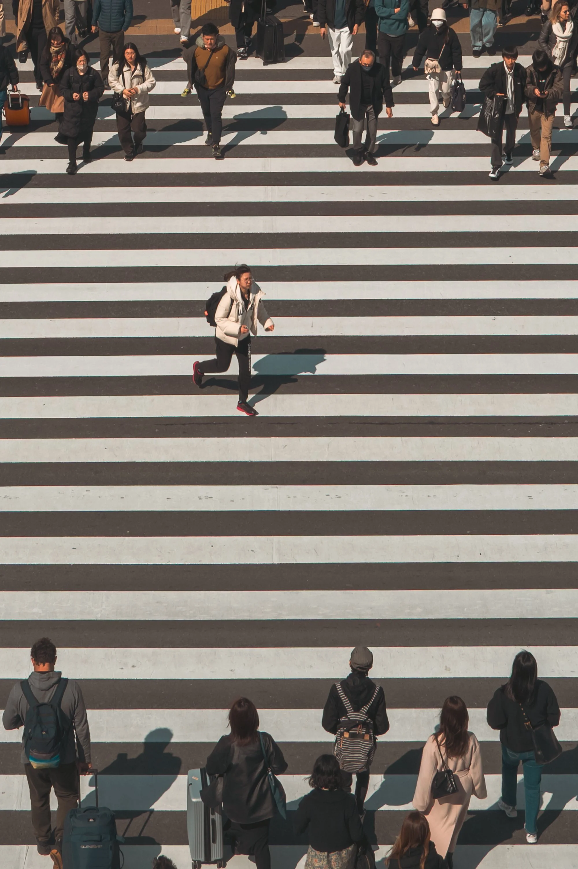 Print AD-0019. A runner crossing a striped pedestrian crossing.