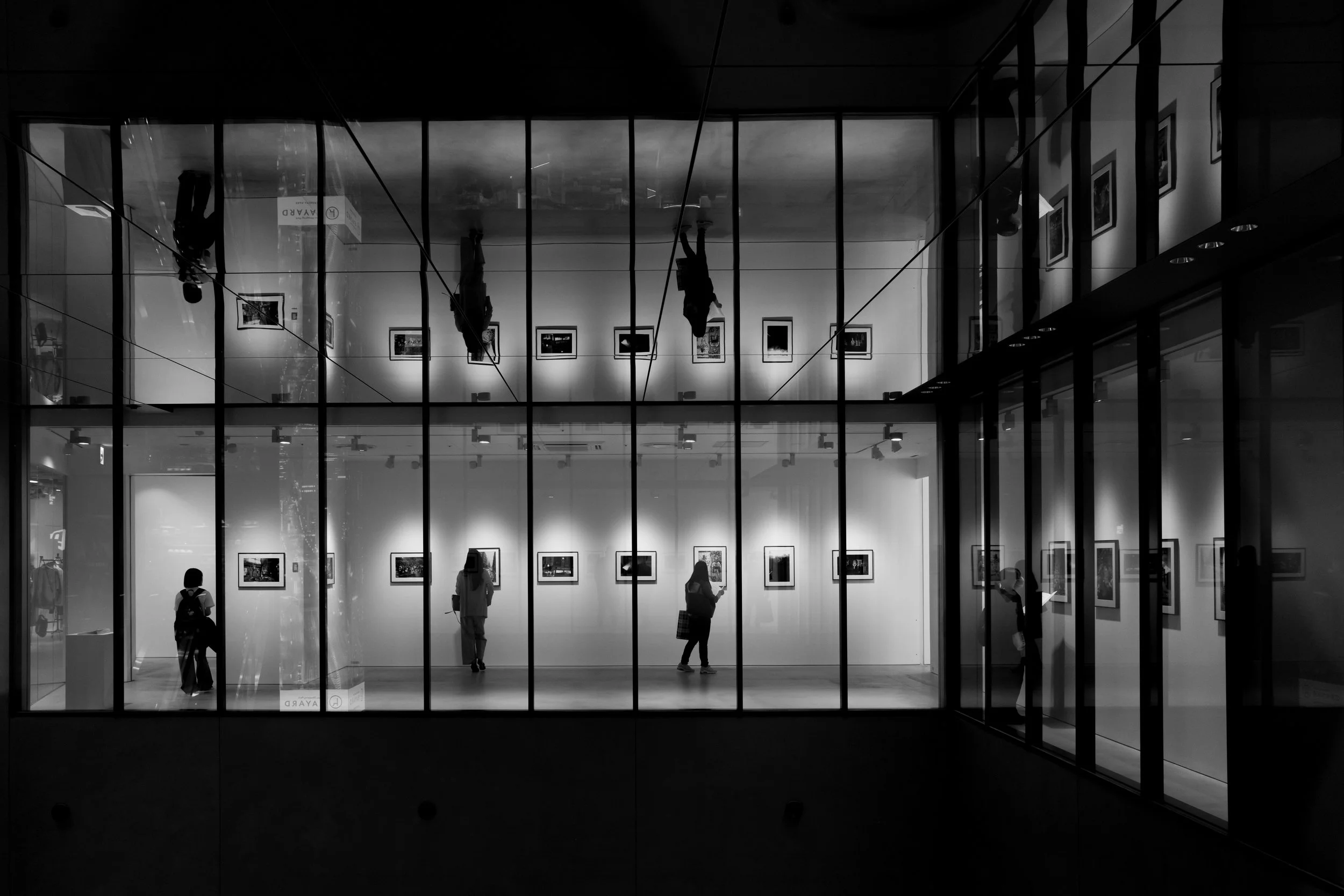 Print AD-0011. People framed within an architectural scene.