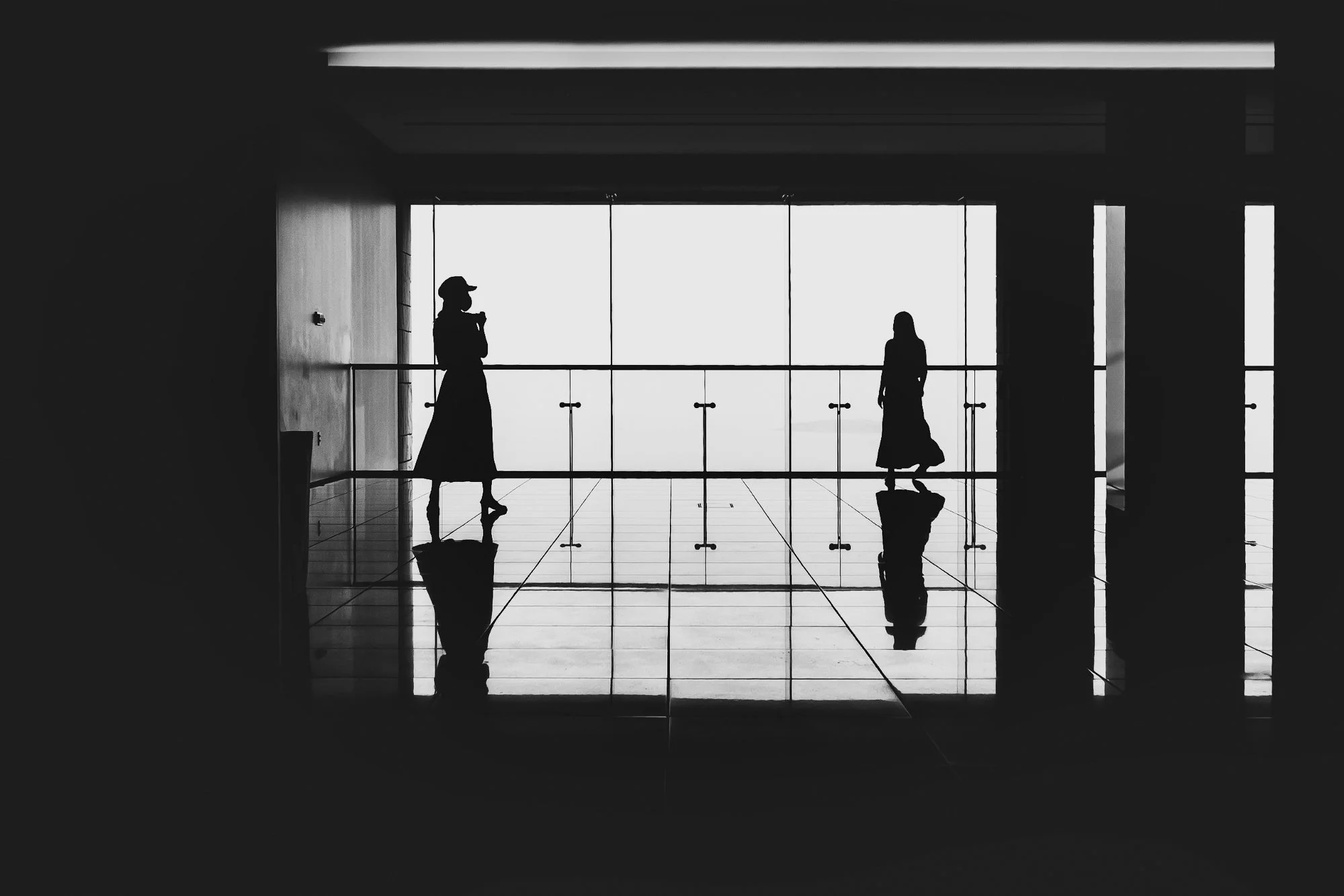 Print AD-0010. Silhouettes crossing a reflective floor.