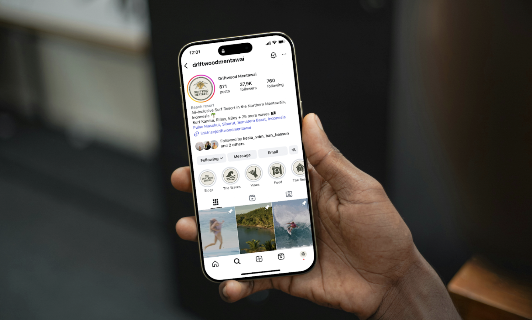 Person holding a smartphone displaying the Instagram profile of Driftwood Mentawai, a surf resort with 37.9k followers.