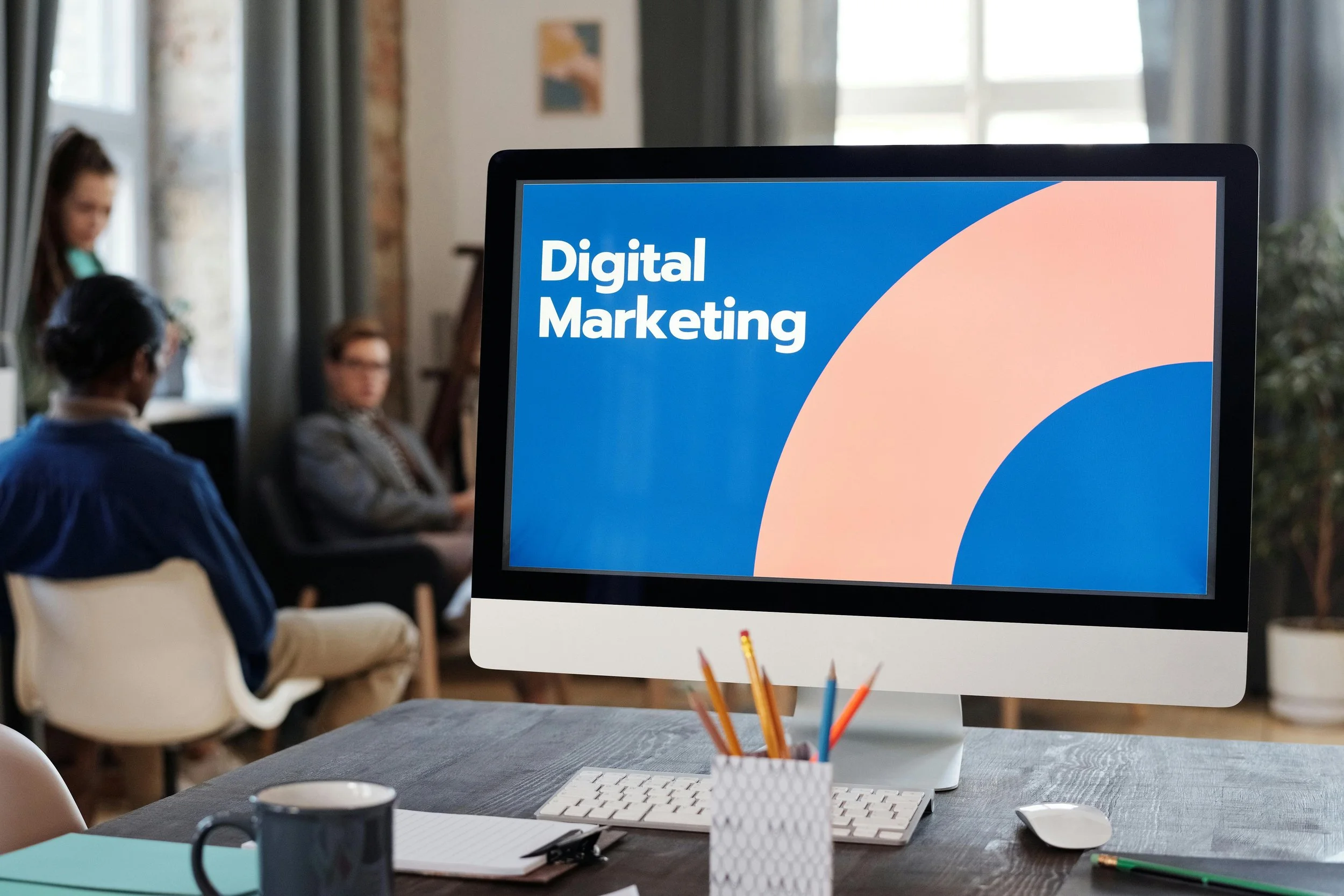 Desktop screen showing Digital Marketing presentation in office setting