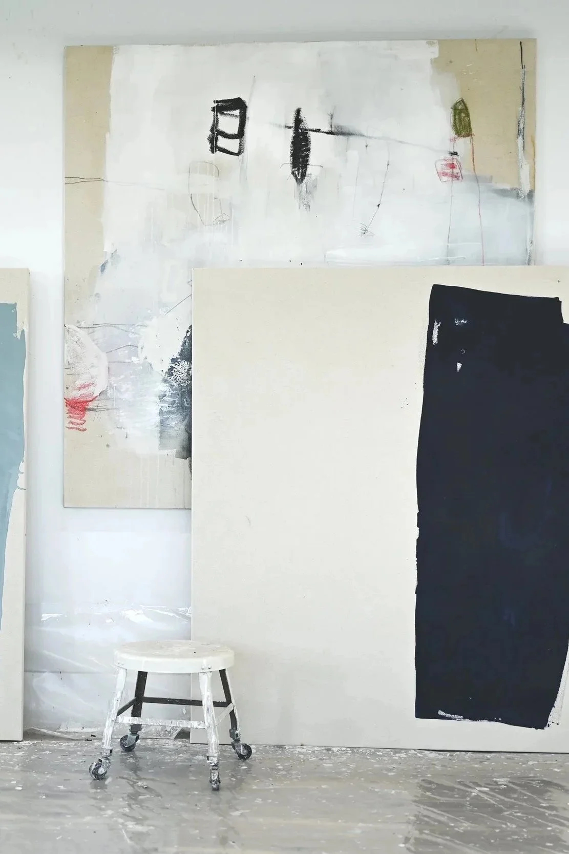 several pieces of artwork by Chris Brandell stacked in the first Marco Island studio