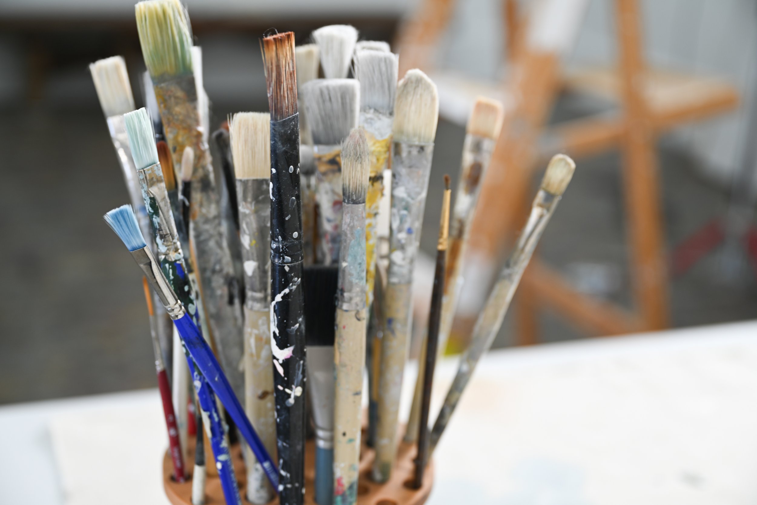 close up detail of chris Brandell's paint brushes in her studio
