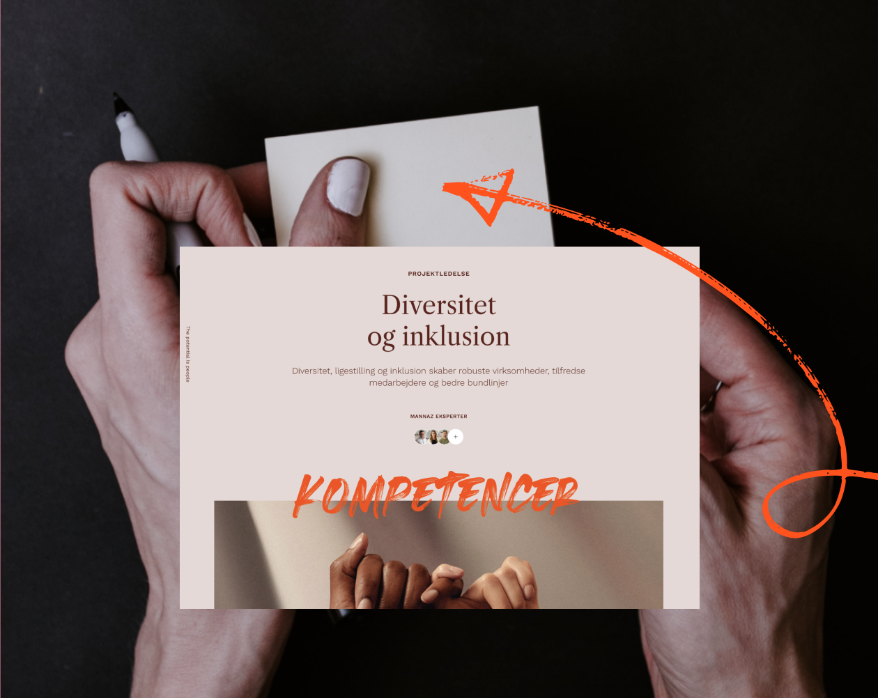A person's hand holding a smartphone with a webpage about diversity and inclusion, featuring the word 'KOMPETENCER' in bold orange letters and a photo of diverse hands clasped together.