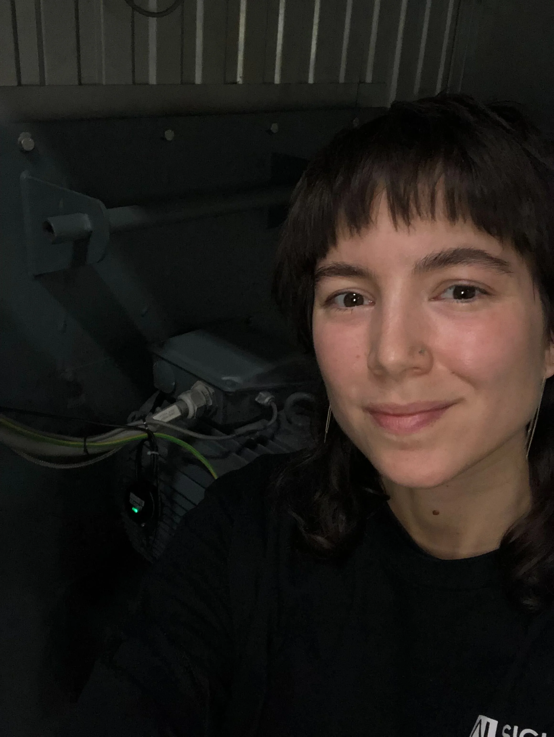 Photo of the UX designer next to an industrial engine