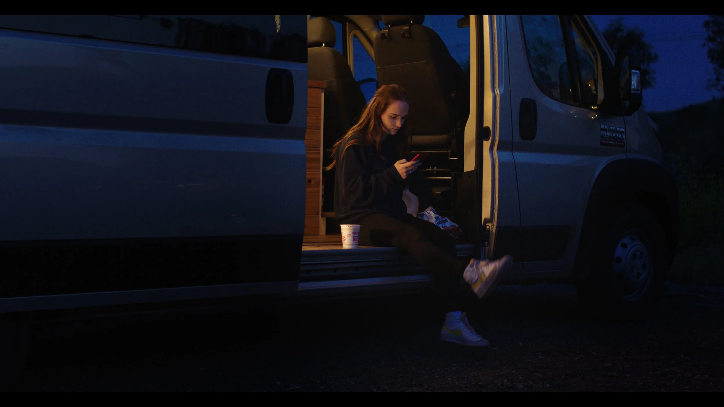 Ash enjoys some ramen noodles while checking for likes