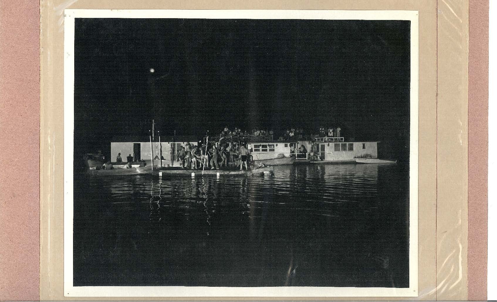 Photo labeled "1940's" shows several boats tied together with dance floor for night time party