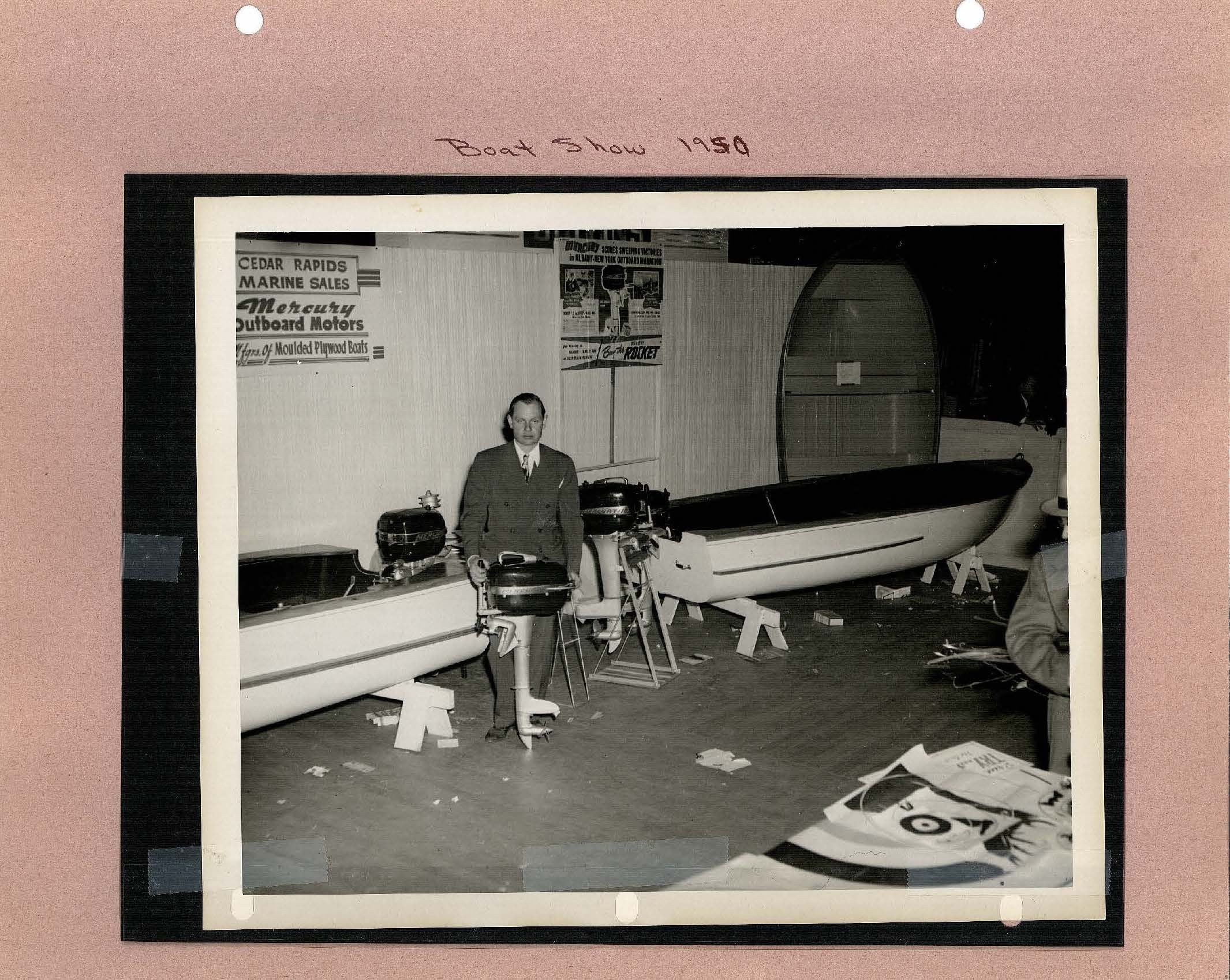 Photo taken at Boat show 1950 of man with outboard motor