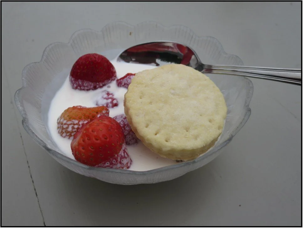 bowl of strawberries, cream and scone