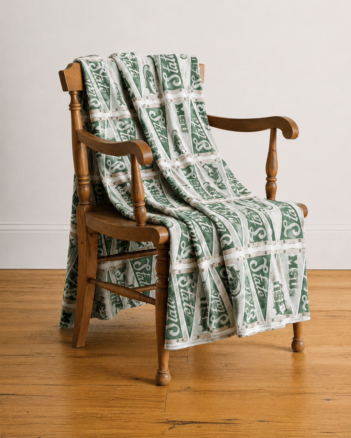 Abigail Leigh Designs MSU State Pendent Blanket on chair.png