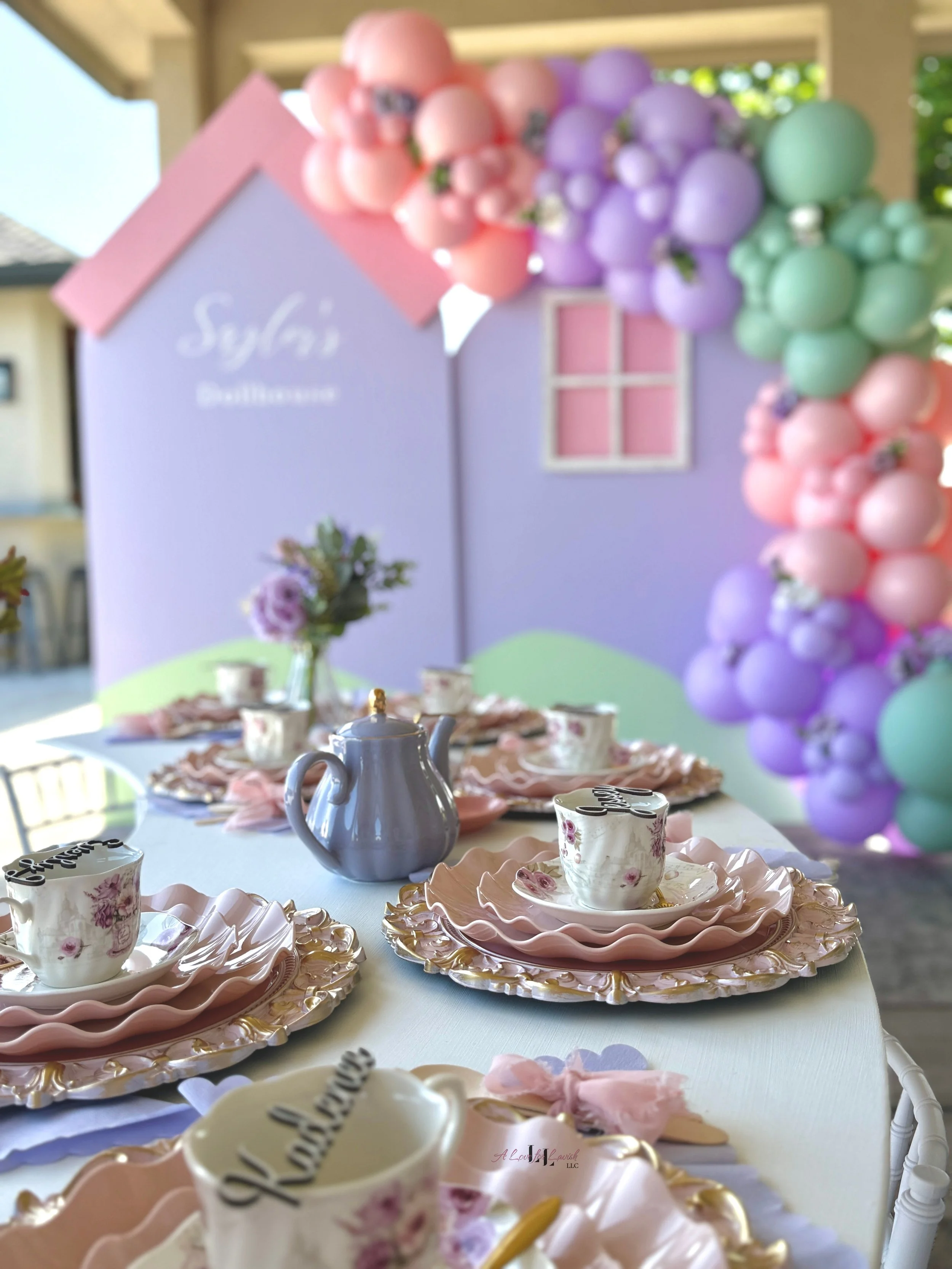Tea party dollhouse teatime pastel backdrop balloons pink purple mint green tablescape custom place cards dolls doll party birthday event planner fancy setup garland floral bay area central valley book