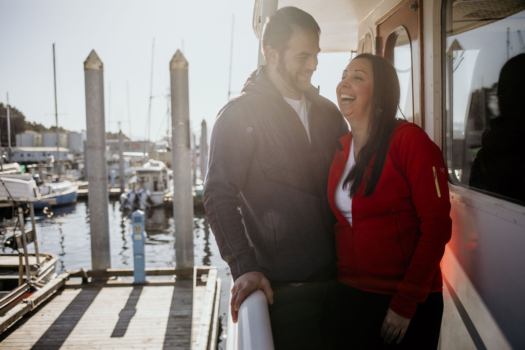 Brian and Jeren on their boat smiling in soft sunny light.