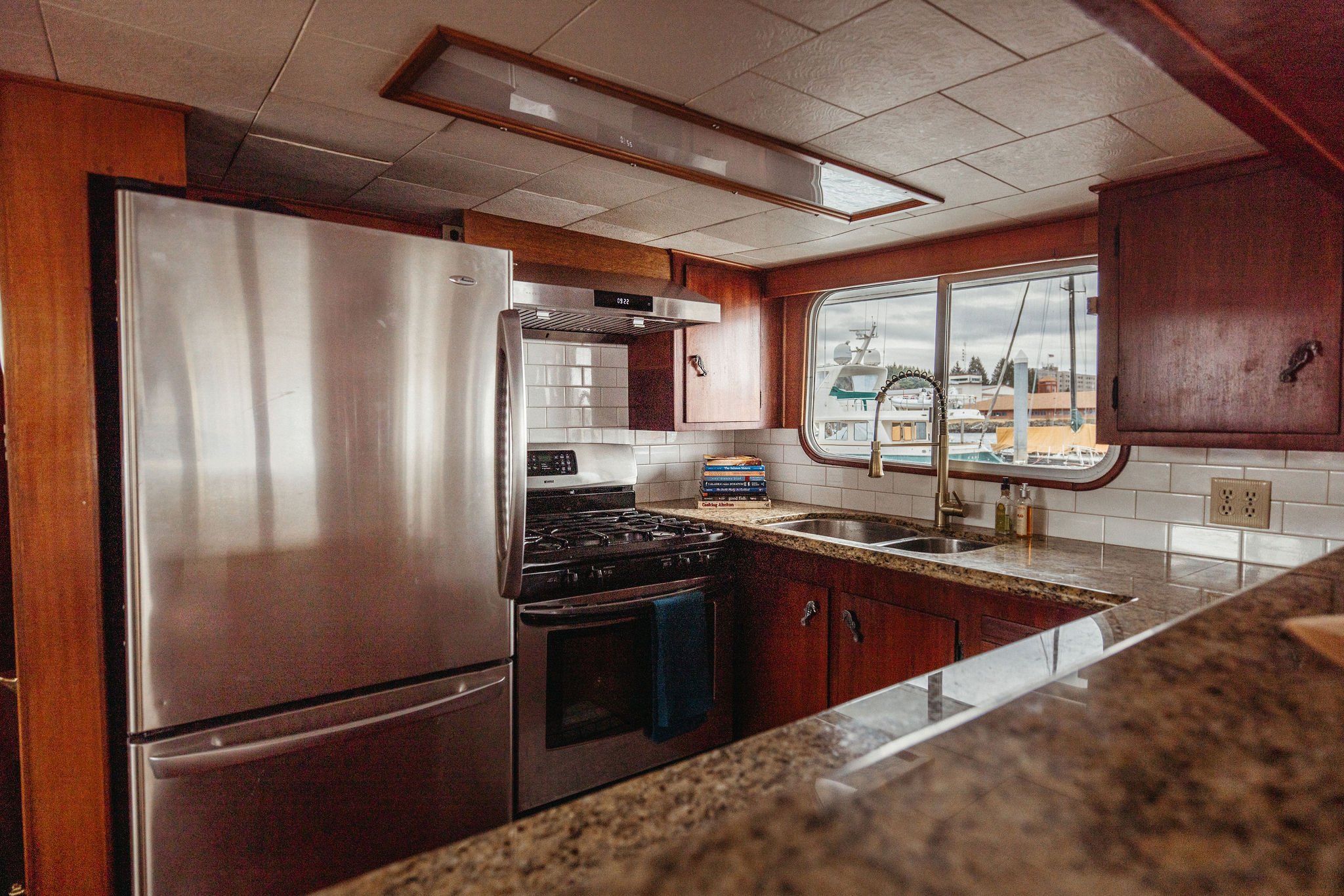 Galley of the Silver Lady with stainless steel fridge, gas cooktop and granite counters.