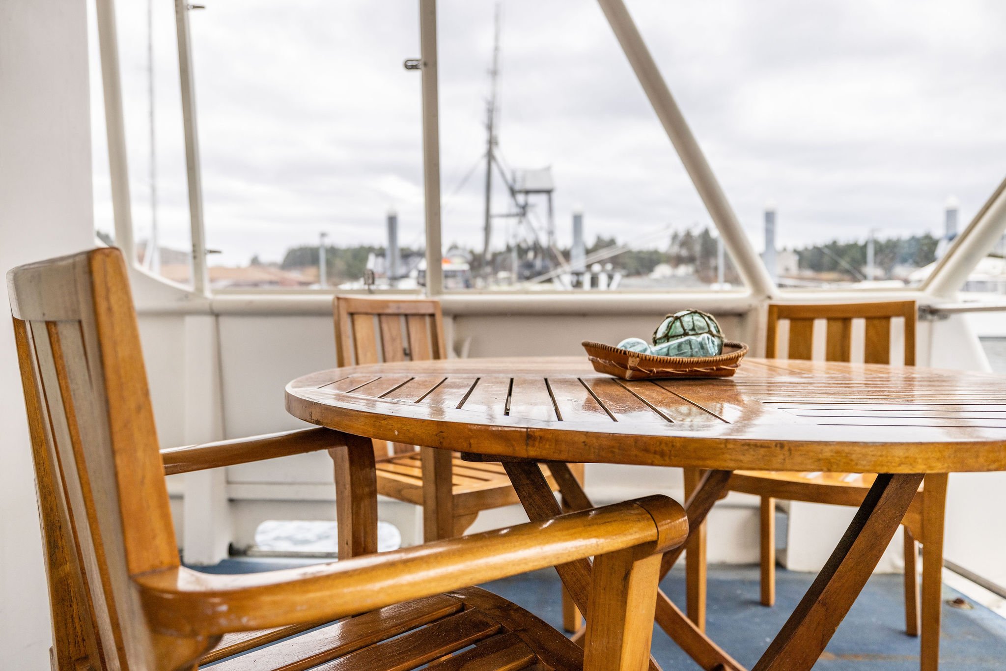 Teak dining table and chairs on the back deck of the Silver Lady.