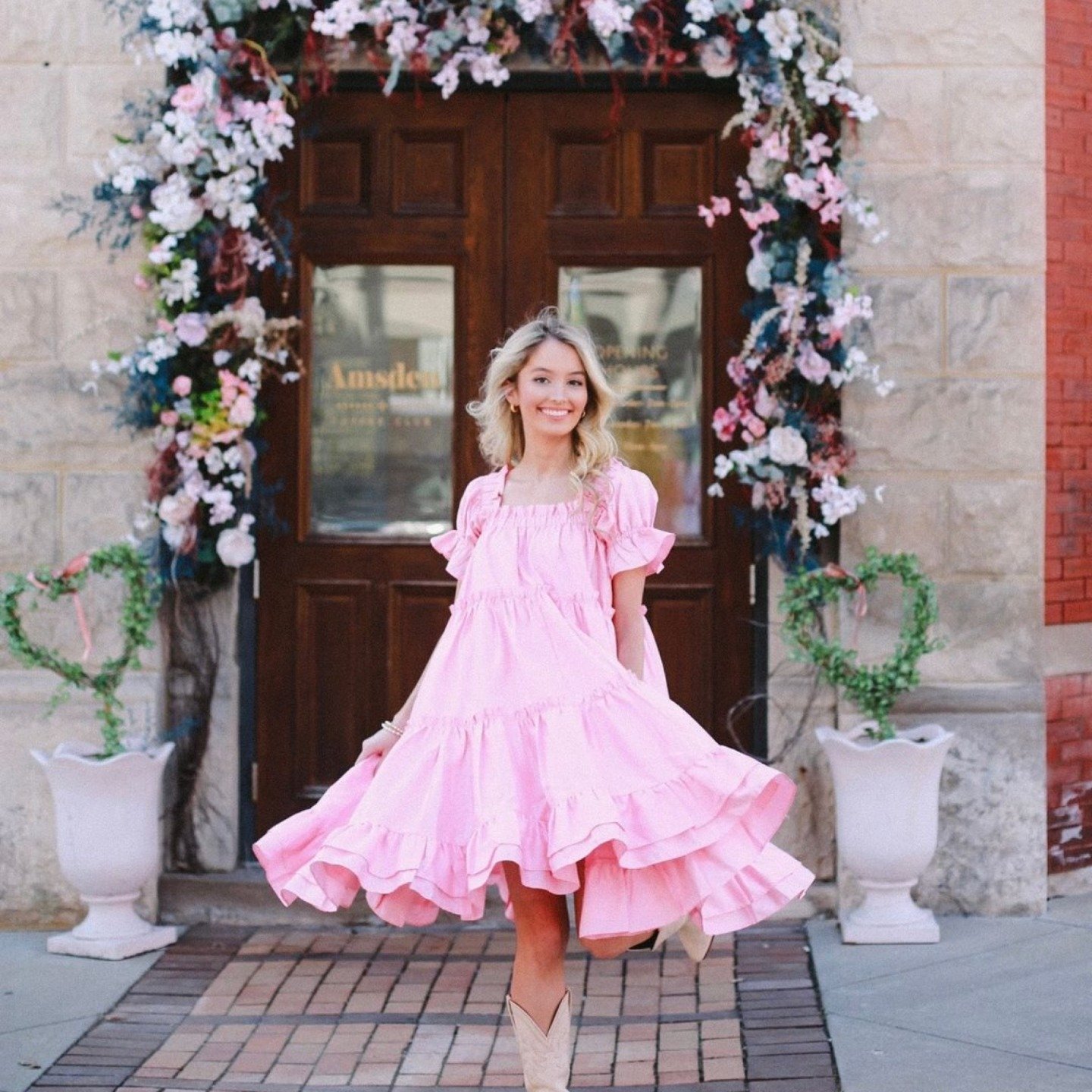 Twirling into Derby season like... 🐎💃 Rocking this stunning pink dress by @elizabethwilsondesigns outside The Amsden, captured beautifully by @thekentuckyguide. Who's ready for mint juleps and horse races? 🌸🥃 Don't forget to swing by the mercanti