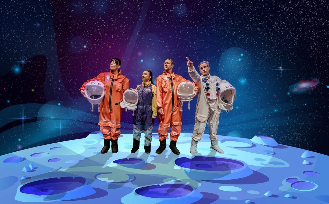 Four astronauts, including a young girl, stand on a lunar-like surface gazing into the starry distance.