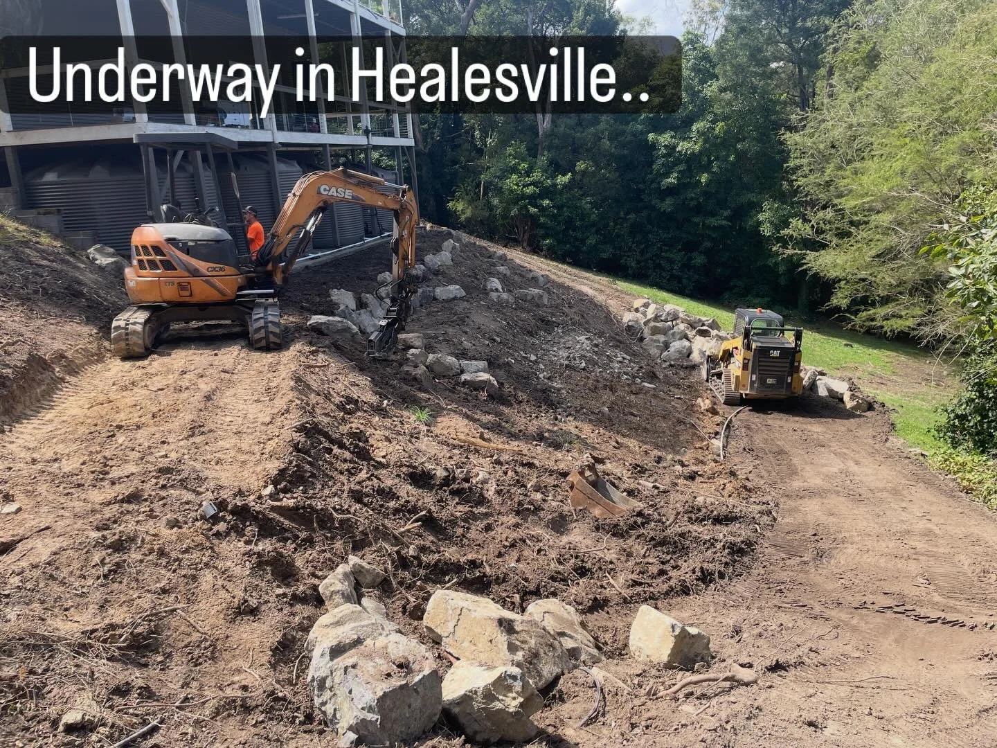 This very steep site in Healesville is currently undergoing a rear garden transformation. Blue mudstone, rock steppers and, iron bark sleepers lead the way down through what will be a botanical style planting, with a dry river bed framing the slope, 