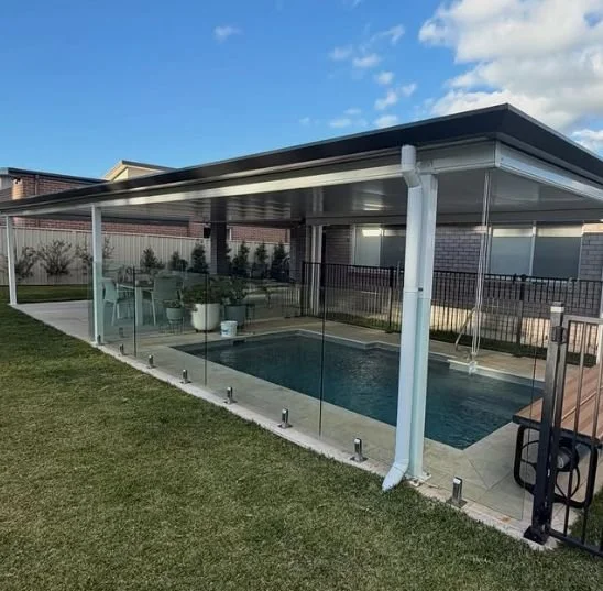 Inground pool covered by a colourbond pergola