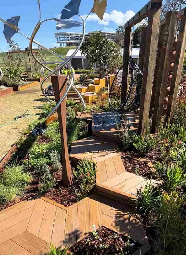 Landscaped garden with timber posts, plants and fresh mulch