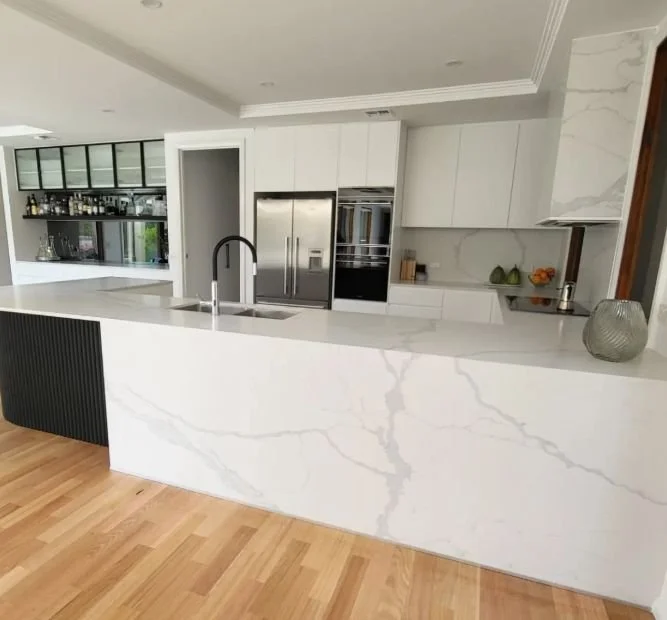 white marble kitchen with black accessories