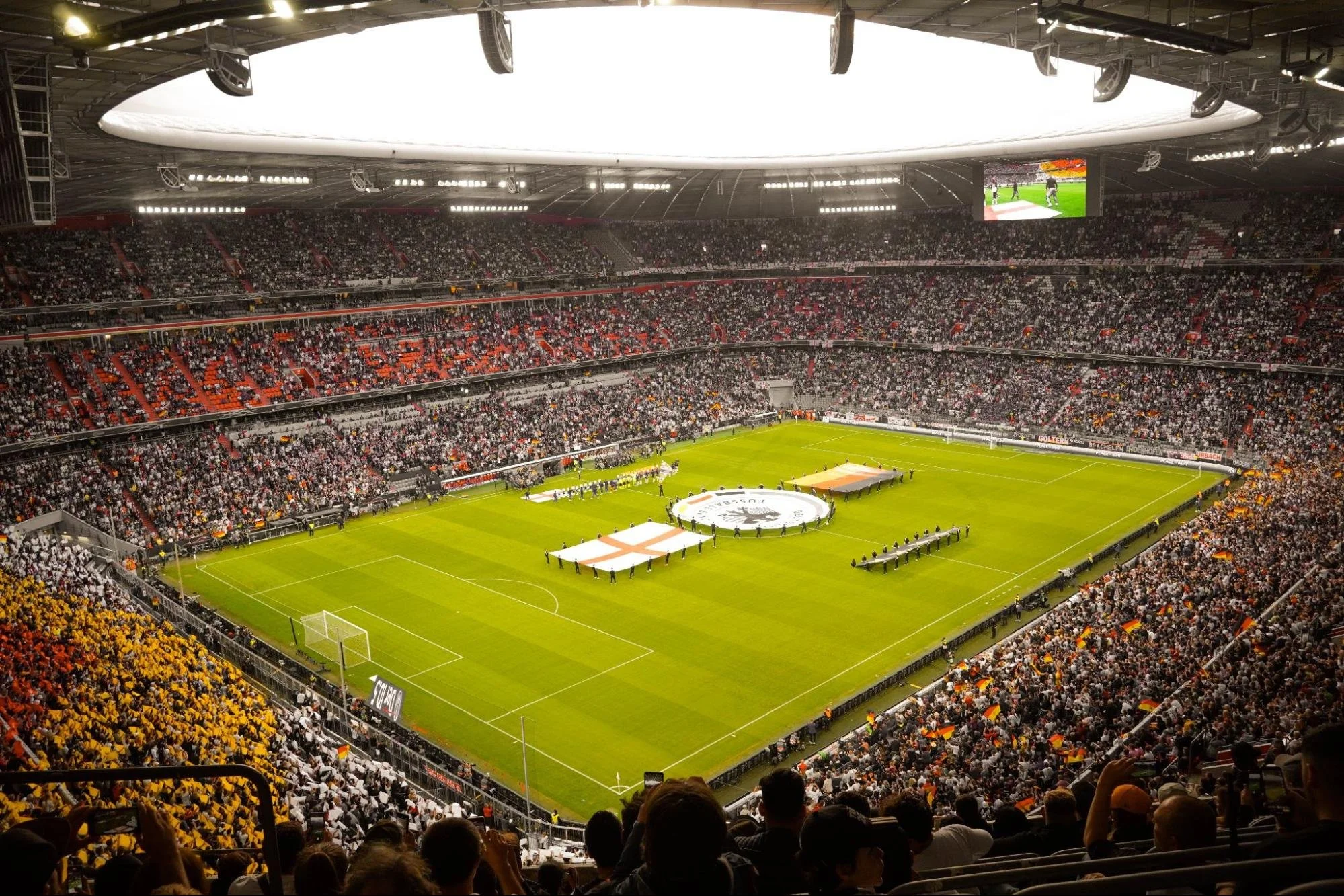 A soccer stadium packed with fans at the start of the game. Source - Pexels