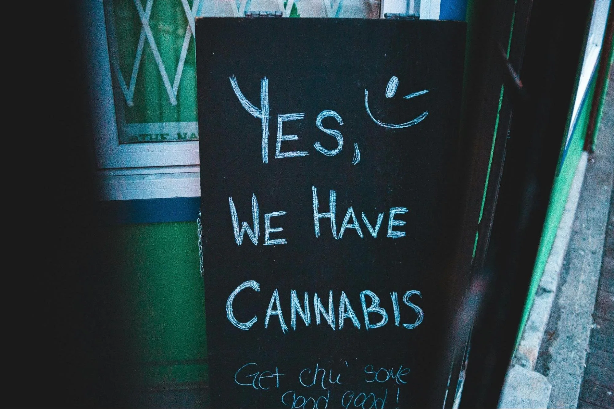 A board outside a dispensary advertising cannabis products. Source - Pexels
