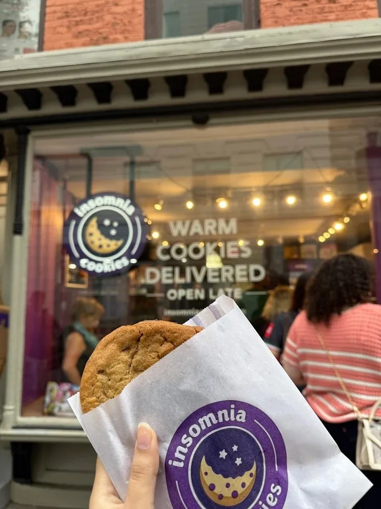 Person holding cooking outside of Insomnia Cookies 