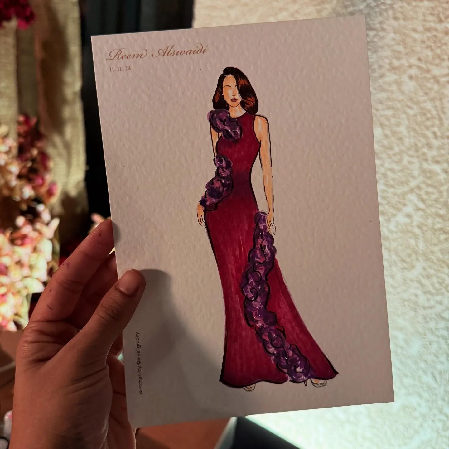 Illustration of a woman in a long, elegant red gown with purple flower embellishments.