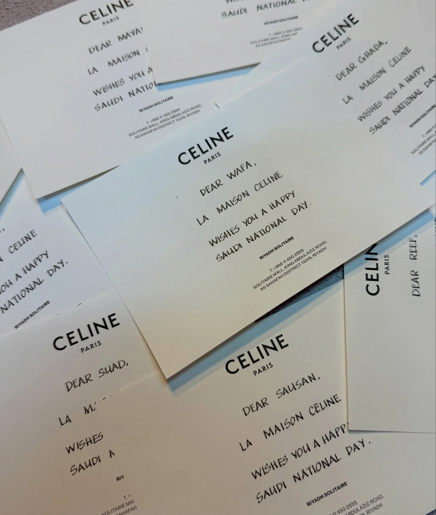 Several printed notes from Celine Paris with messages wishing a happy Saudi National Day, addressed to various people.