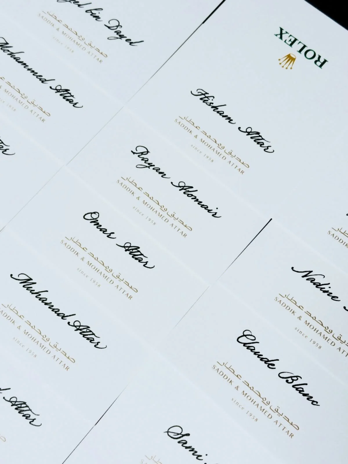 A sheet of paper with printed text featuring the Rolex logo, and the names 'Tifany Shah,' 'Bayram Altan,' and 'Omar Altan,' along with Arabic script and the phrase 'Saddik & Mohammed Attar since 1958'.