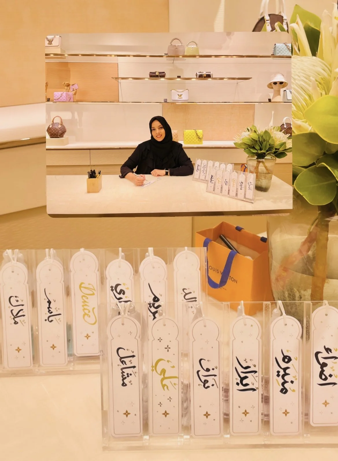 A woman sitting at a counter with shelves displaying handbags behind her, and a potted plant on the right. Front and center are several white tags with Arabic writing, and a Louis Vuitton shopping bag on the counter.