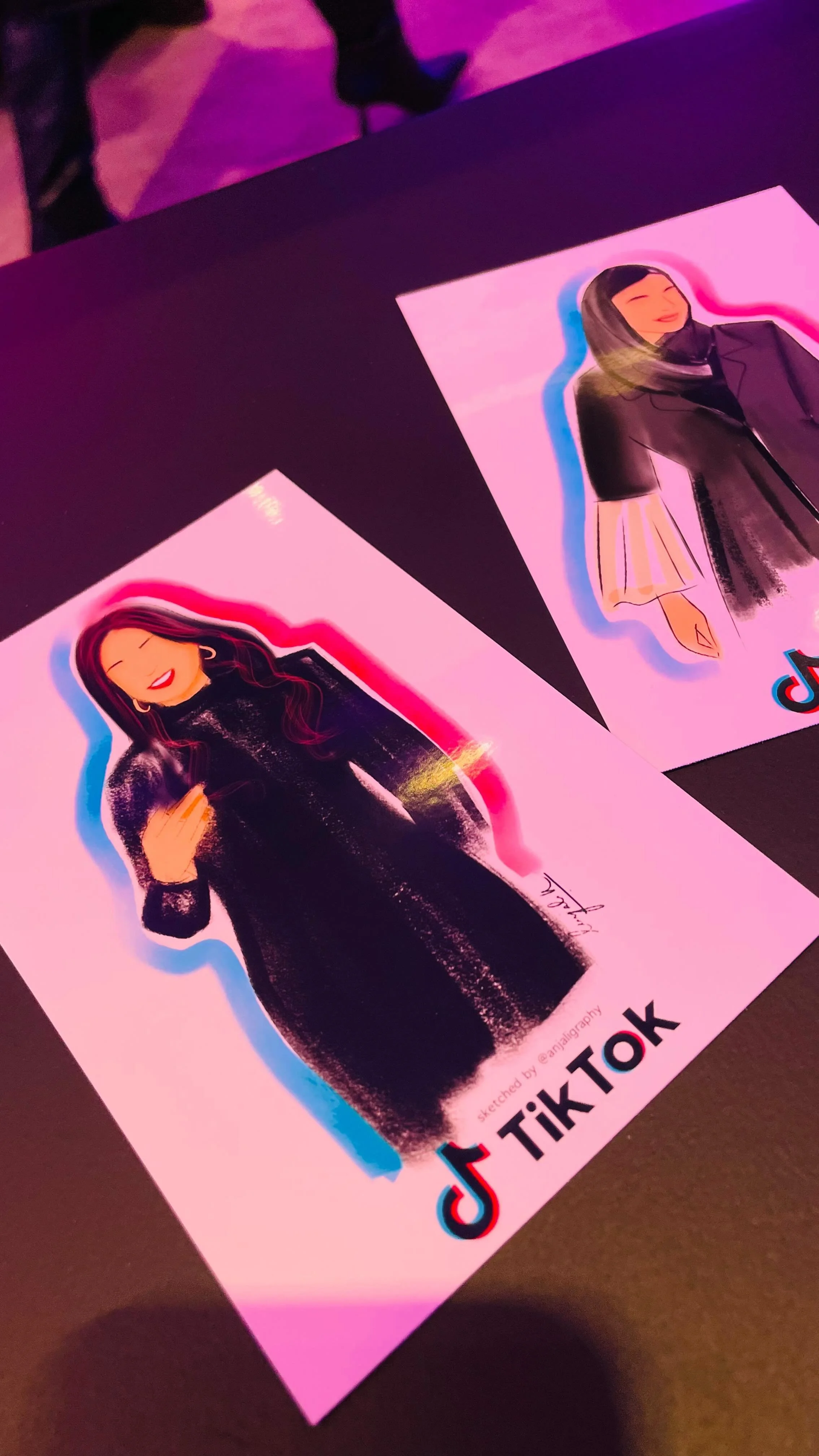 Colorful TikTok stickers of illustrated women on pink paper.