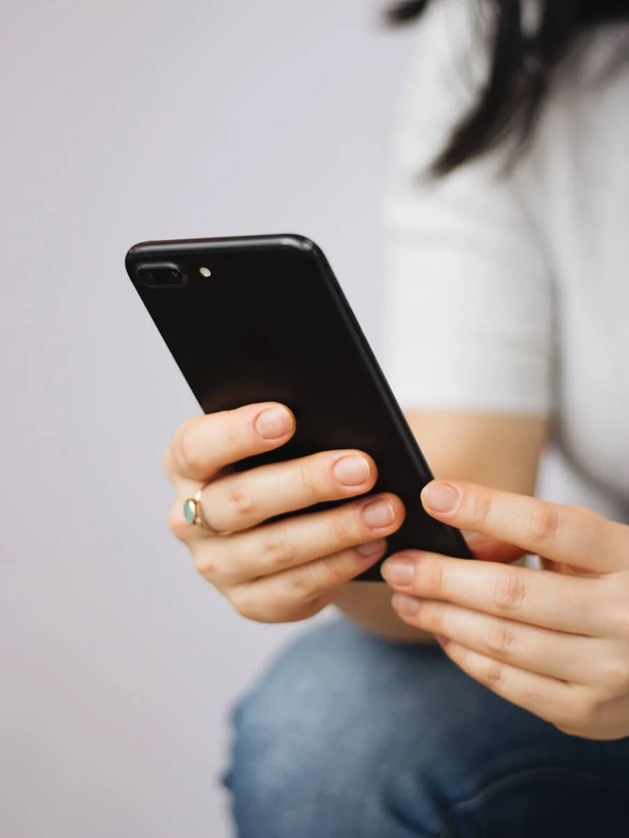 Close up of Danbee's hands holding an iphone