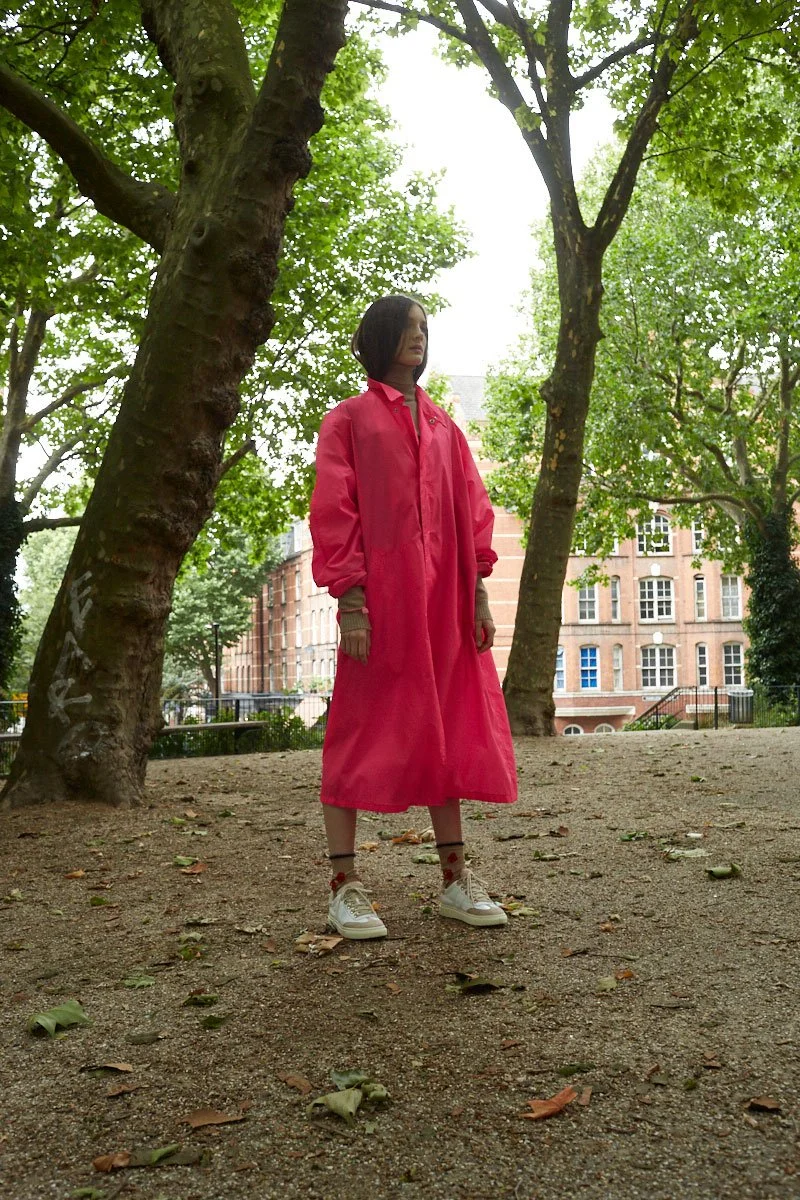 Model in a bold pink oversized coat styled by Zoe James, photographed for Flair by Roger Deckker.
