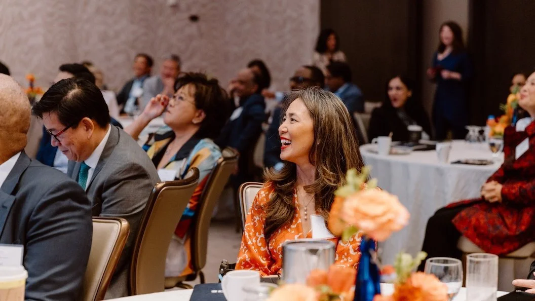 woman smiles in audience at Ascend Pinnacle Board Leadership Summit